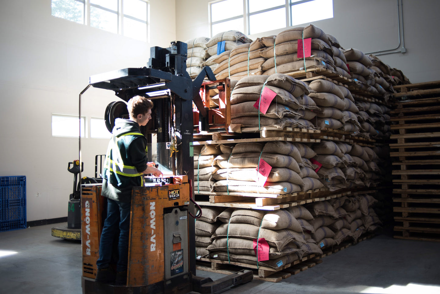 Forklift picking up a pallet of coffee sacks. 